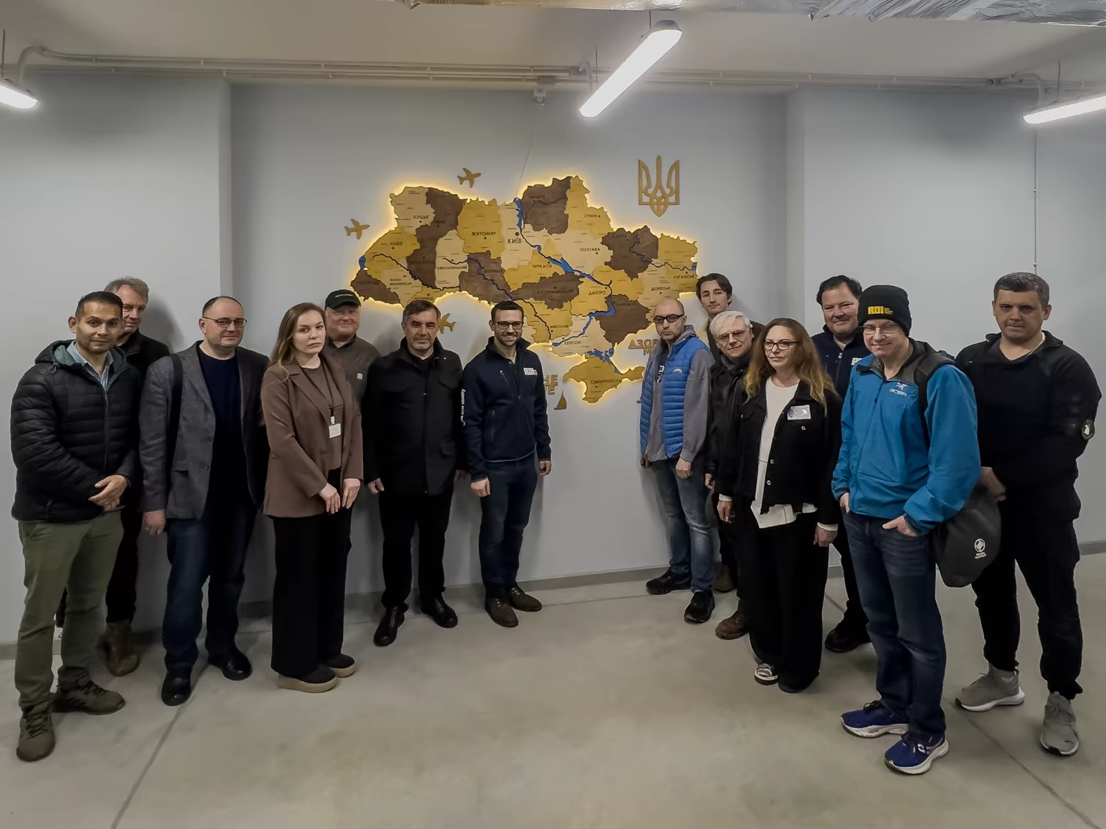 RDI delegation in Ukraine before a map of the country